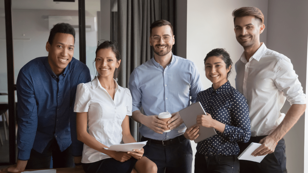 A diverse group of individuals gathered around a table, engrossed in a discussion about "how to build a team."
